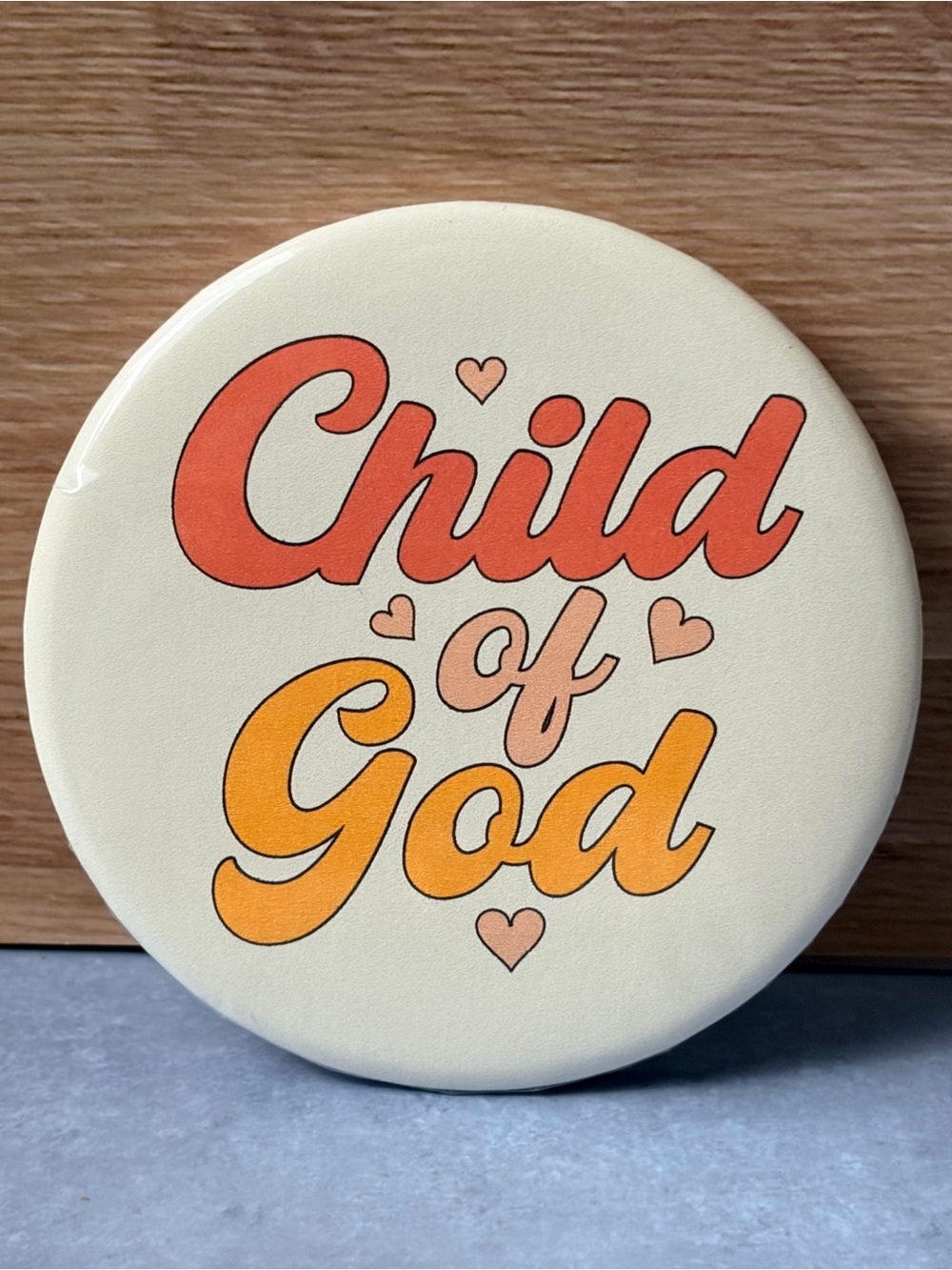 Child of God Cream Button Badge with Orange & Coral Lettering